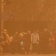 People wait to cross an intersection amid a sandstorm during the morning rush hour in Beijing, Monday, March 15, 2021.